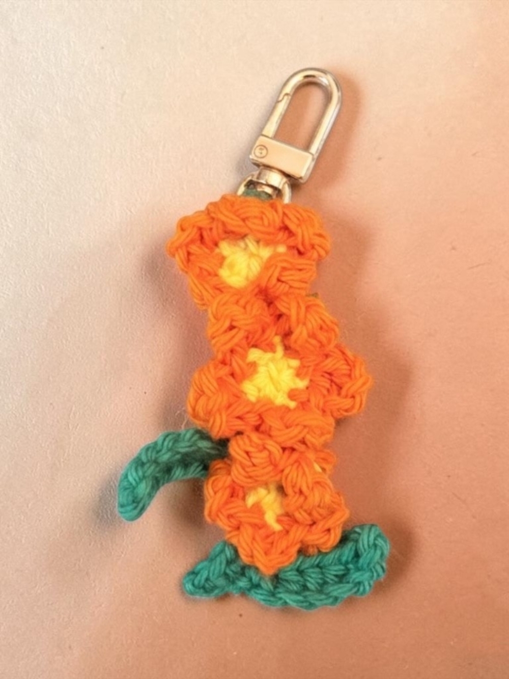 Handmade Orange Crochet Flower Keychain with Teal Leaves